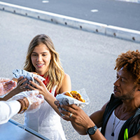 food being handed from food truck